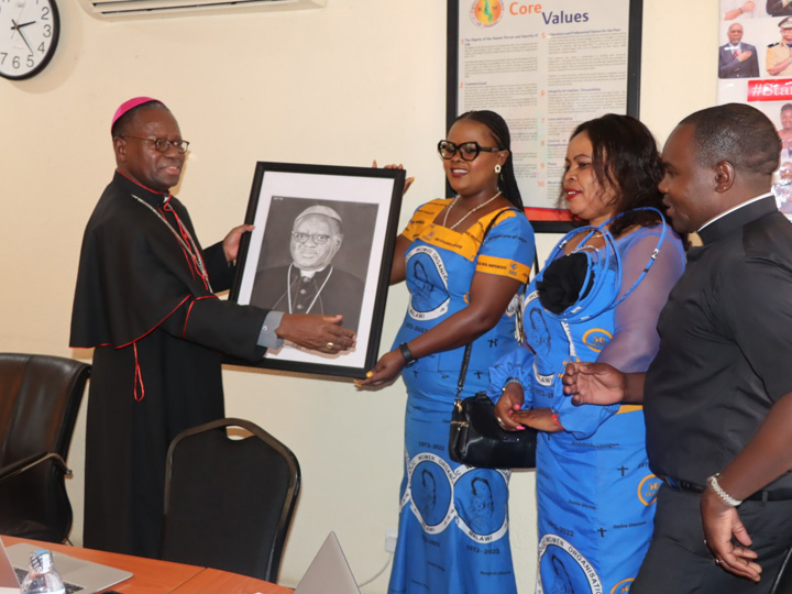 presenting a gift to Bishop Rogath Kimaryo