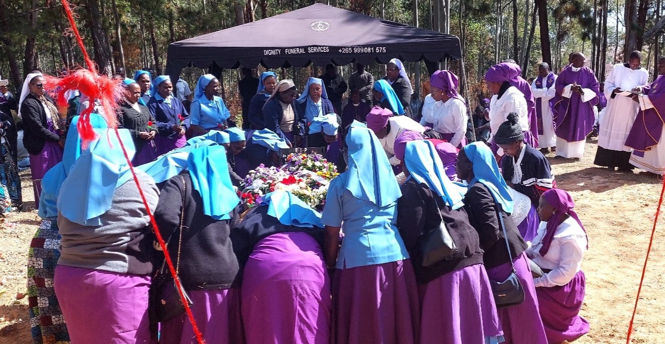 Sisters lay wreaths on Fr Ignatius Mpando's grave